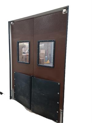 Brown swinging doors with bumpers for forklift traffic.